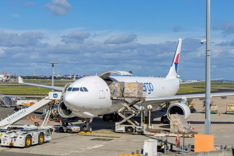 Large cargo aircraft being loaded for international air freight