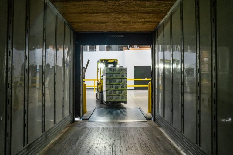 Forklift operator loading palletized cargo for dispatch from a China origin warehouse
