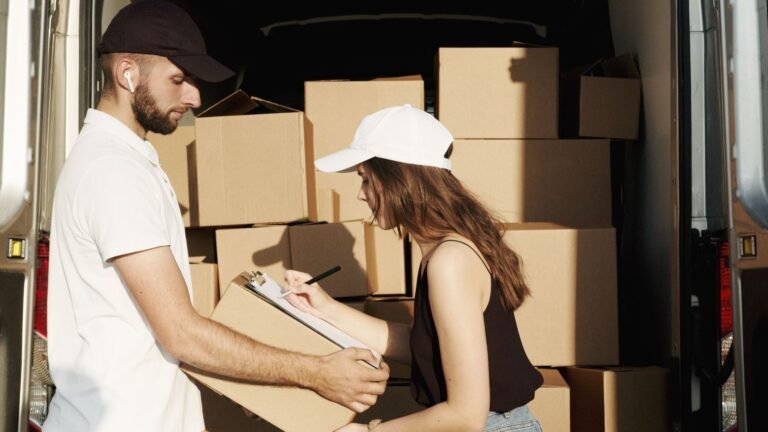 Customer signing delivery documents while receiving cargo from a delivery vehicle