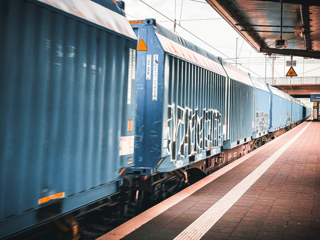 Container freight train moving through a modern rail freight station
