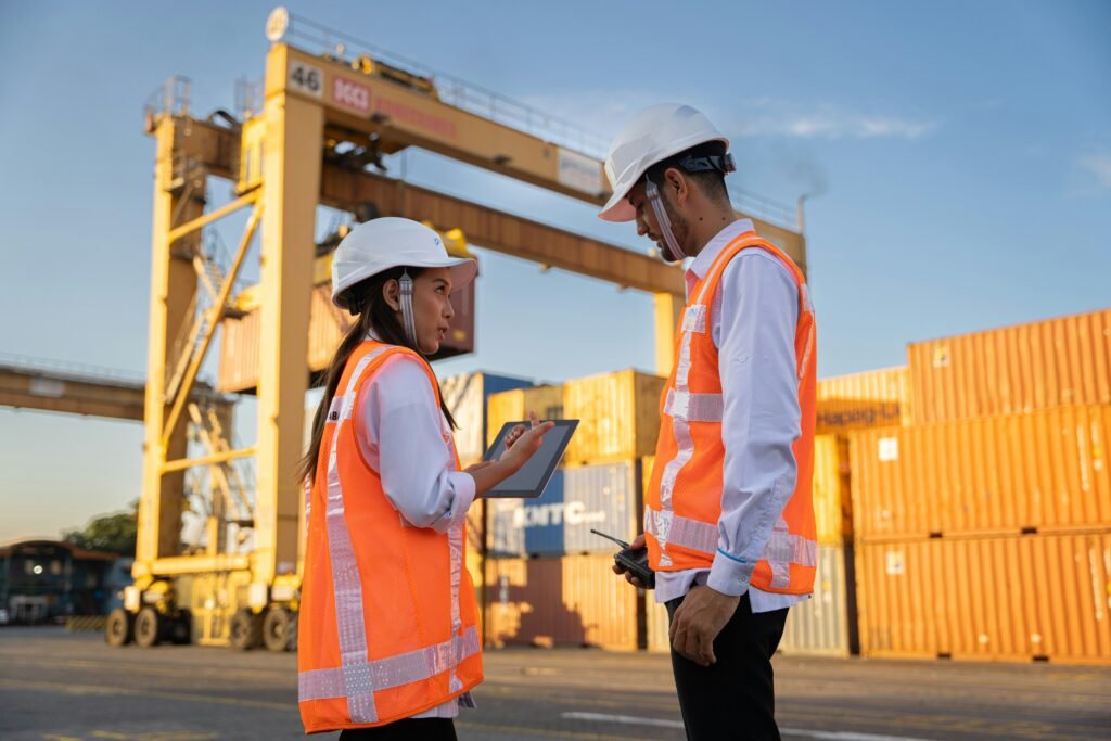 Logistics specialists reviewing container shipping plans at a seaport terminal