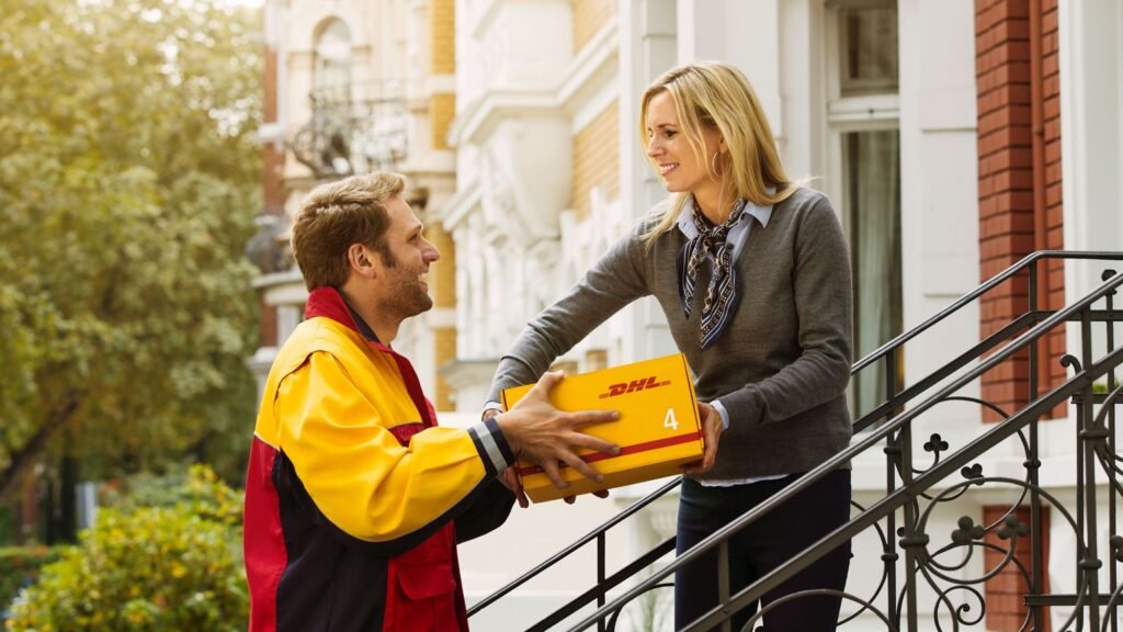 DHL courier handing a branded parcel directly to the recipient at the doorstep